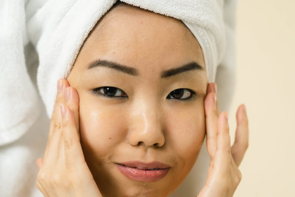 Portrait of a serene woman with a towel wrapped around her head, embodying relaxation and spa beauty.